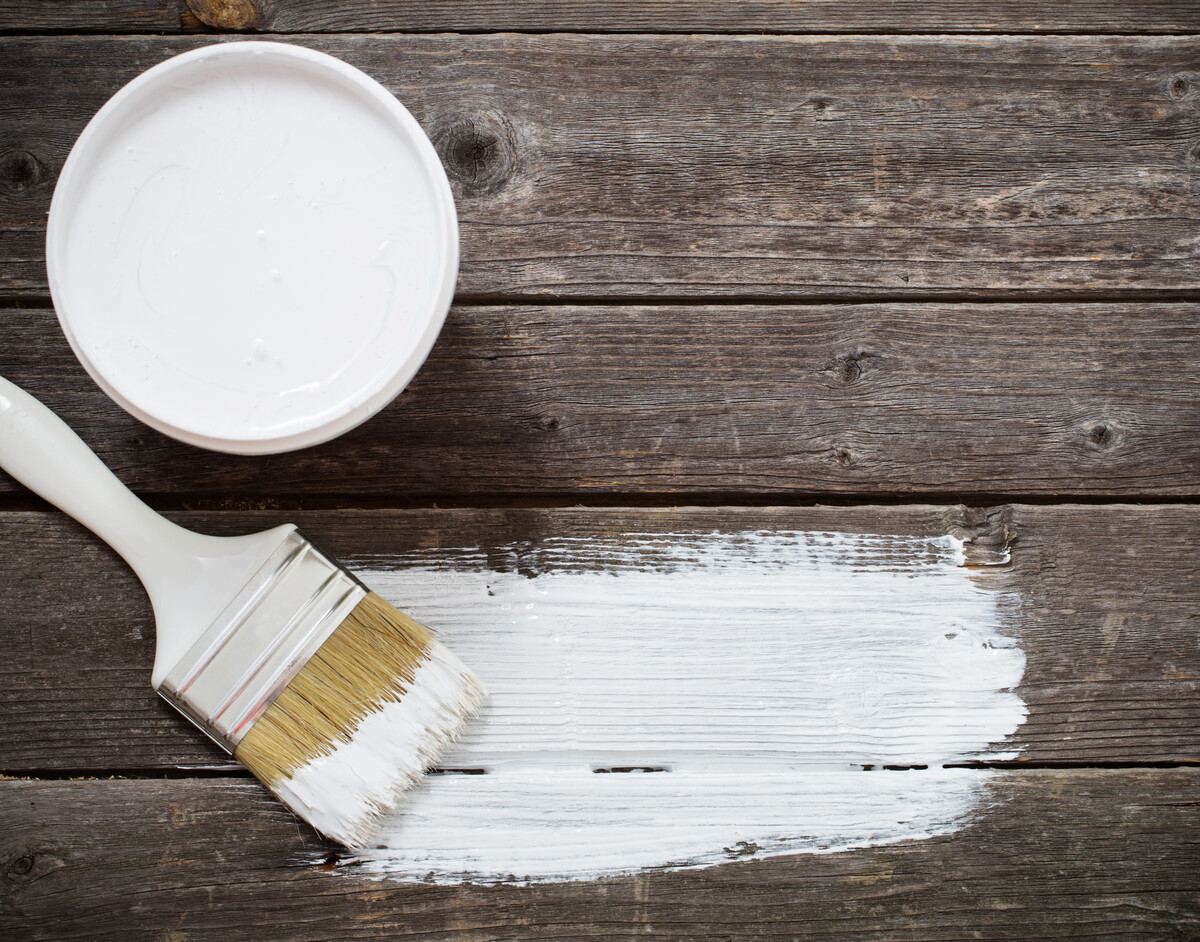 Bank paints and brush on a wooden background